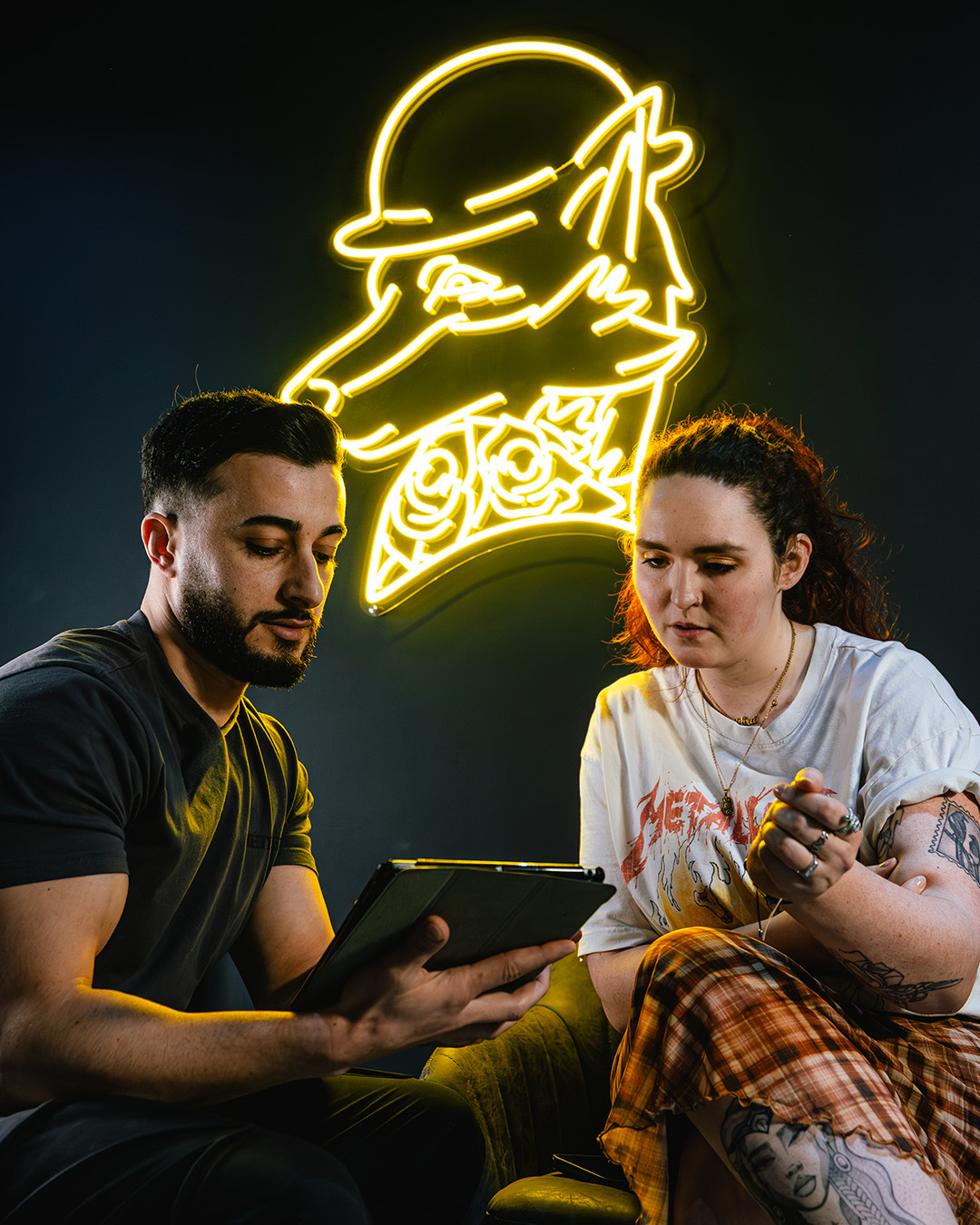 Abbas tattooing a client